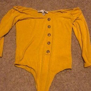 Off the should yellow bodysuit